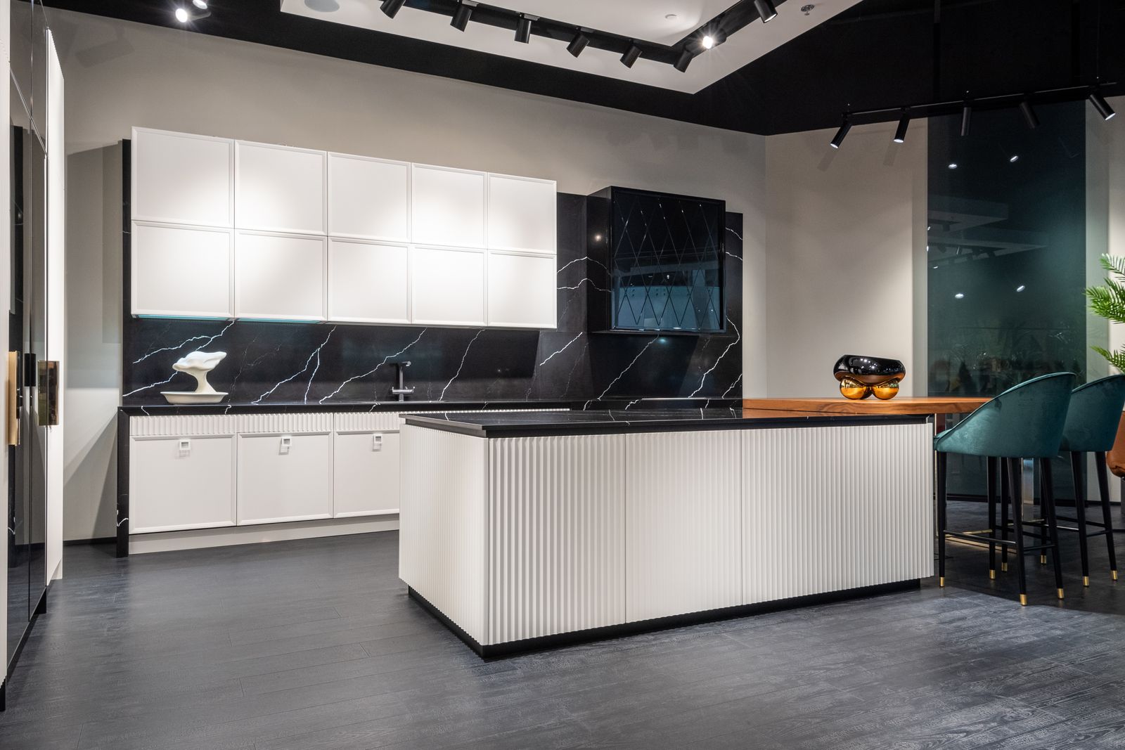 Fitted kitchen with fluted white island and dark marble worktop