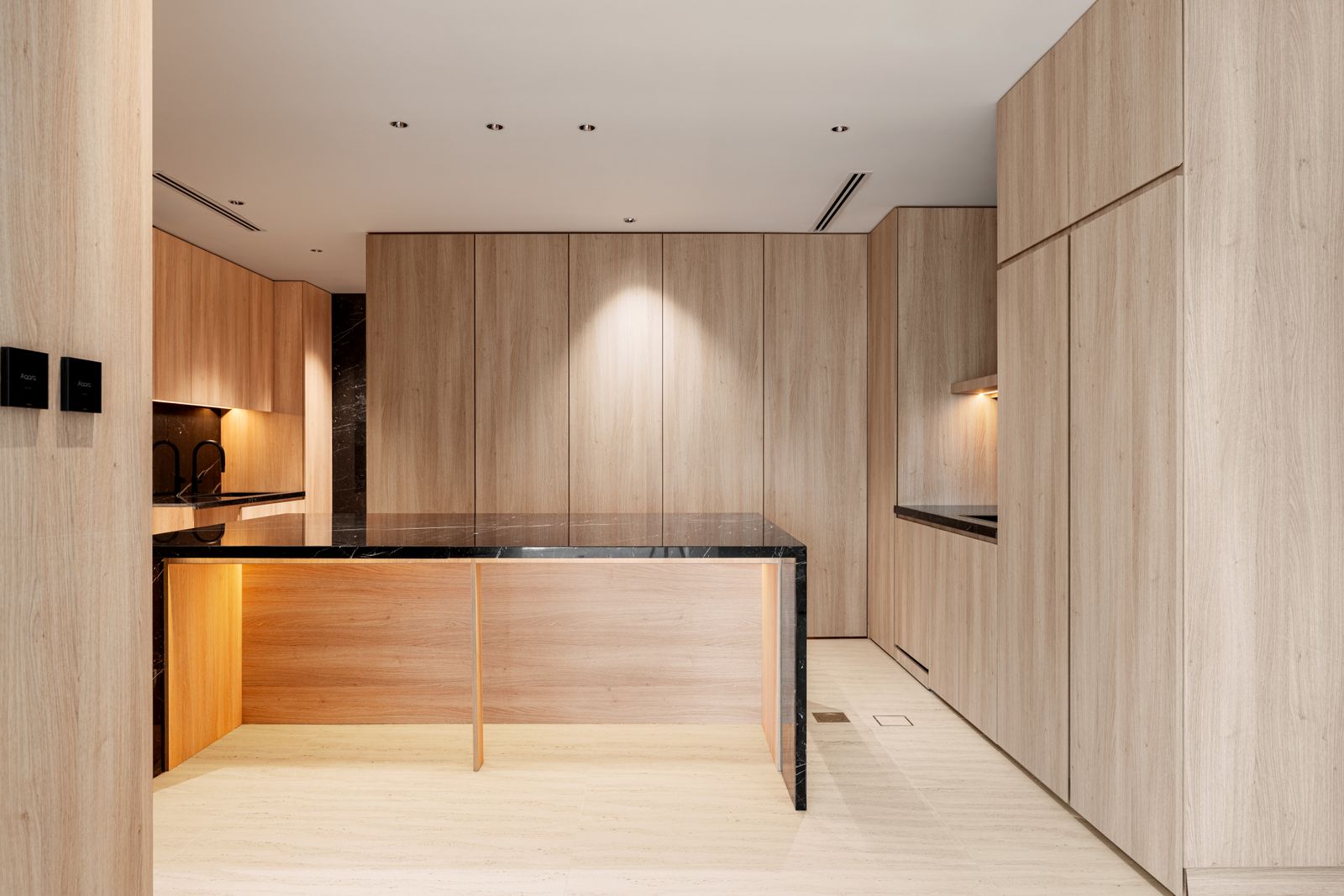 Minimal timber kitchen with black stone worktop